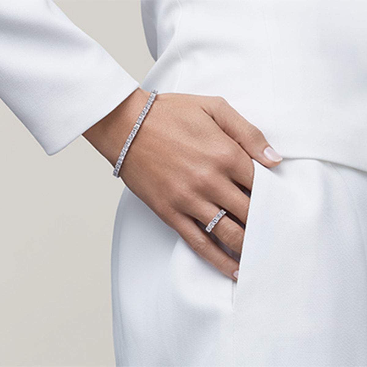 Woman in white wearing a Shimansky Bracelet and ring
