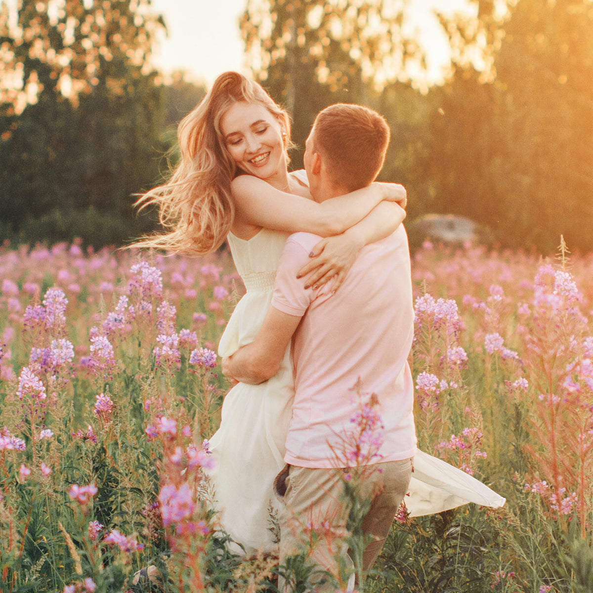 A couple embracing in a vibrant field of colorful flowers, enjoying the beauty of nature together.