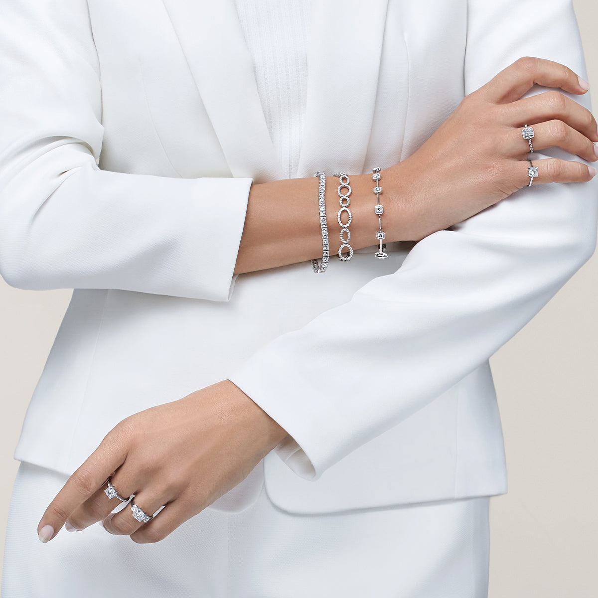 Woman in smart clothing wearing an assortment of the signature My Girl Diamond Cut collection Jewellery