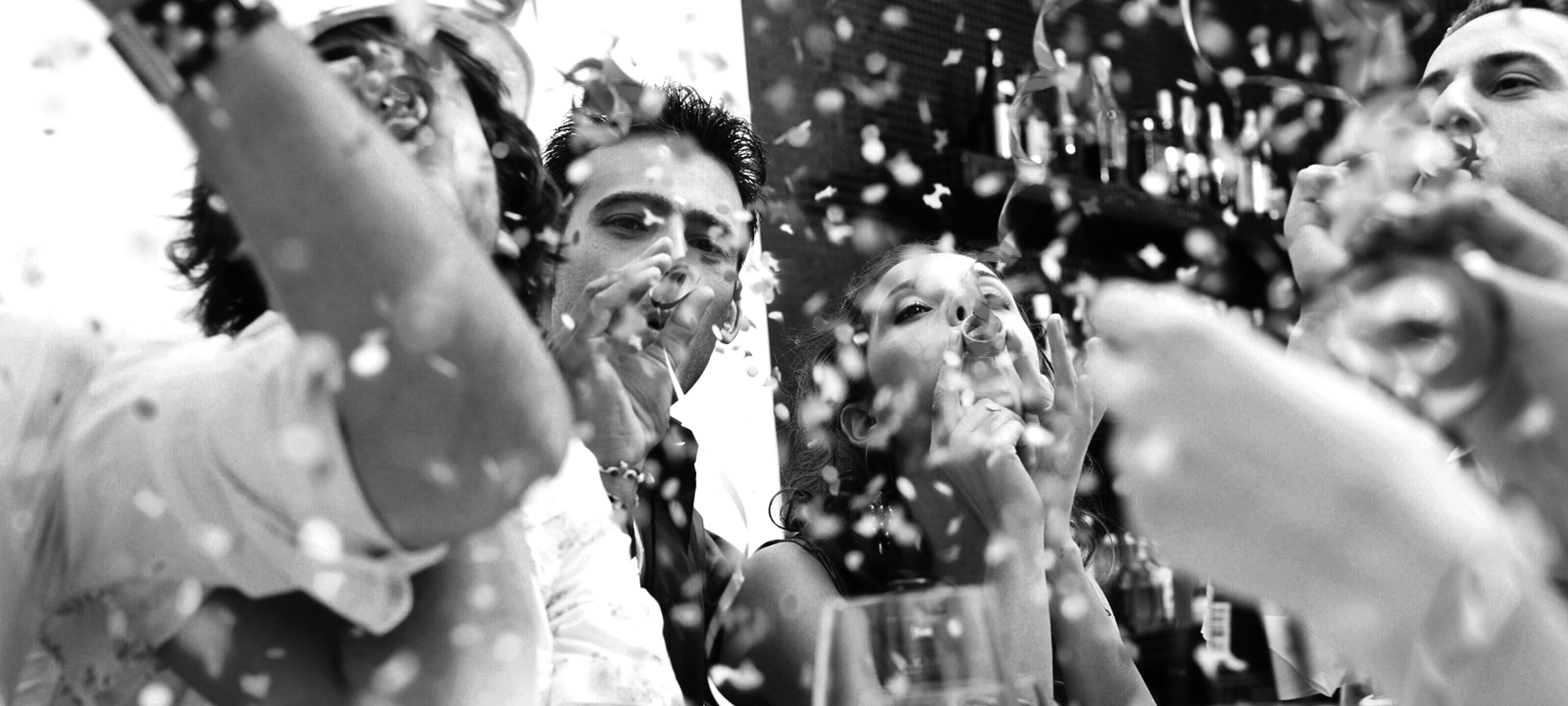 Bridal party blowing bubbles and celebrating at a wedding