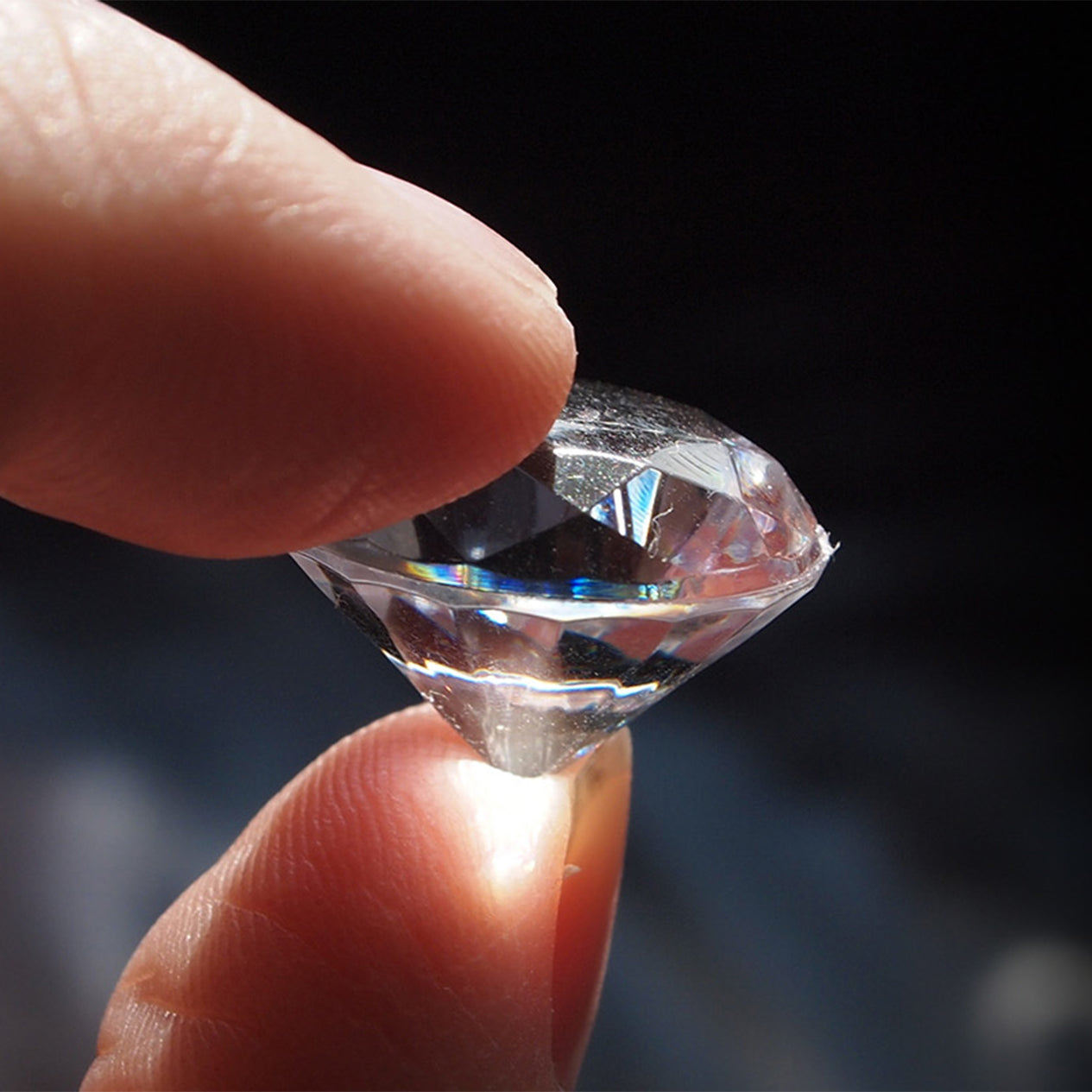 Shimansky Jeweller holding up a cut and shaped diamond into the light
