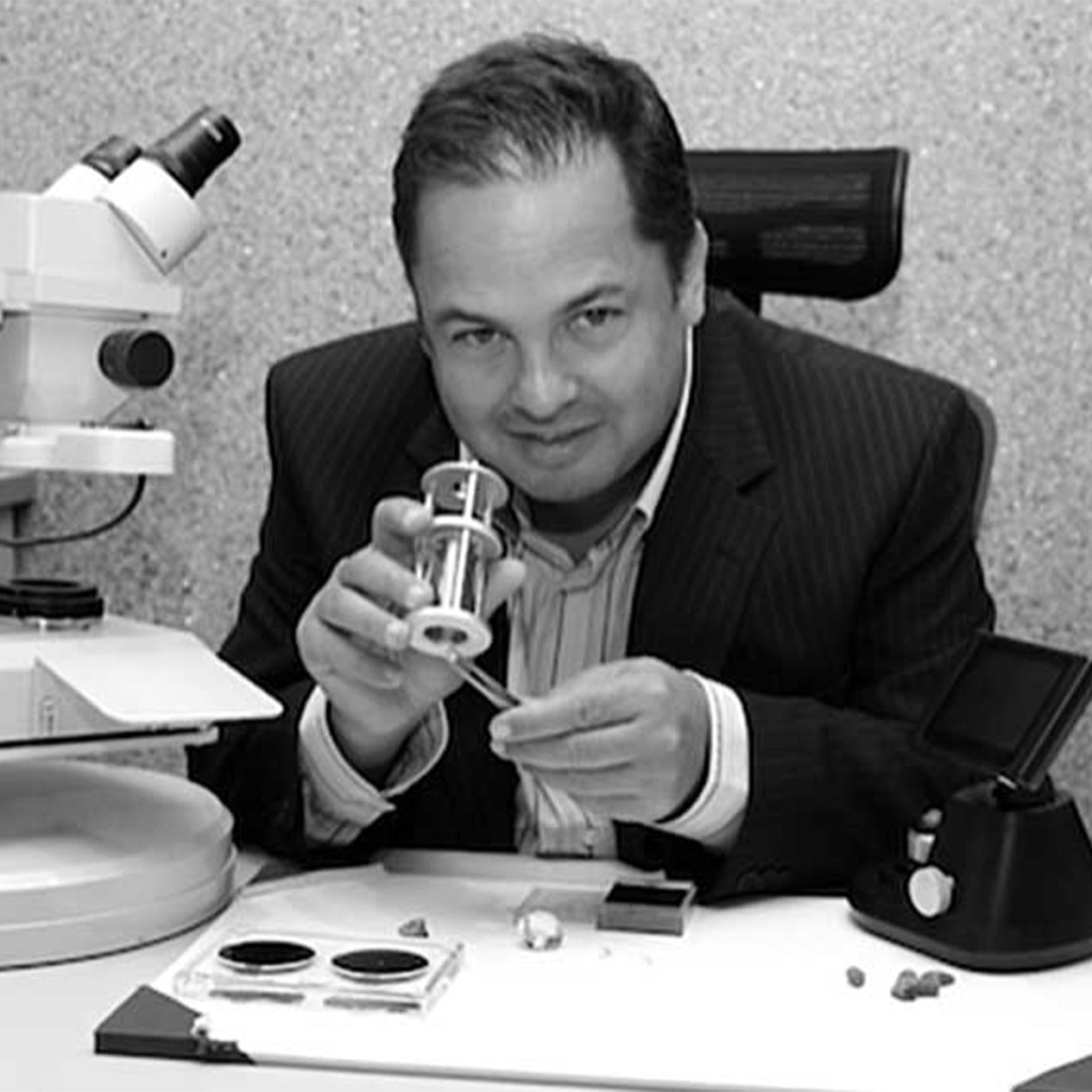 CEO Yair Shimansky happily inspecting diamonds at the jewellery store.