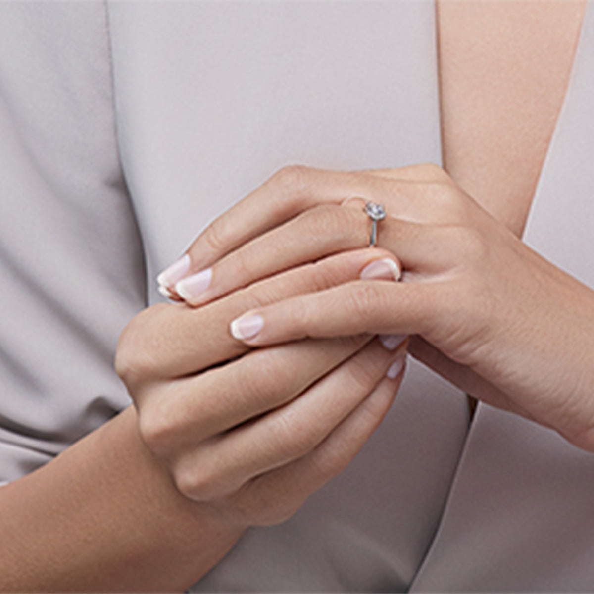 Woman putting on a Shimansky ring on her wedding finger