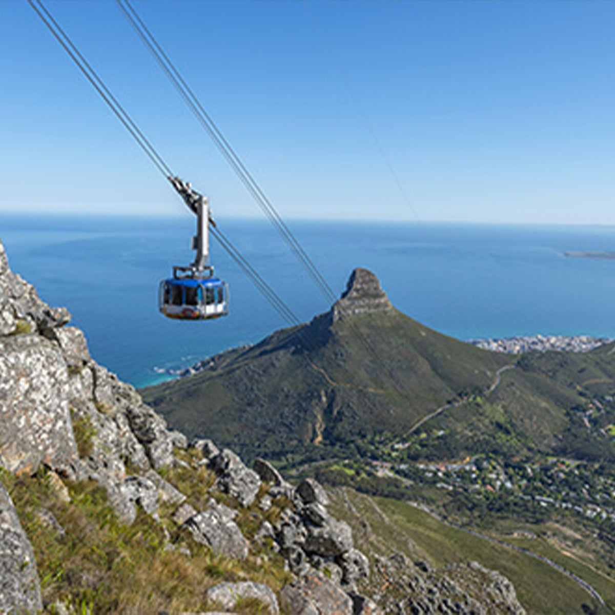 Cape Town Cable car going up Table Mountain with lions head in the background